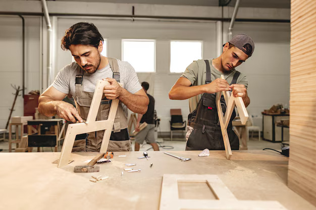 StudyX furniture craftsmen at work in manufacturing facility